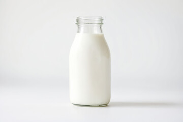 Glass bottle of milk on a white background