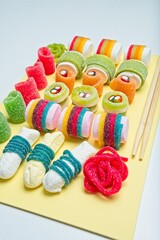 Various jelly strips, candies and marshmallows arranged to look like sushi