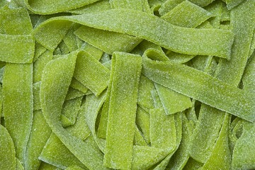 Green sour gummy jelly candy strips in sour apple flavor