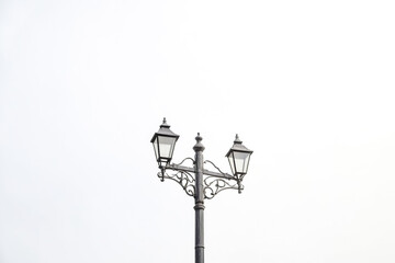 Ornate Street Lamp Against a White Sky