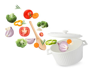 Fresh ingredients falling into saucepan on white background