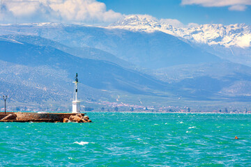 Lighthouse, sea, snow mountains, Nafplio, Greece