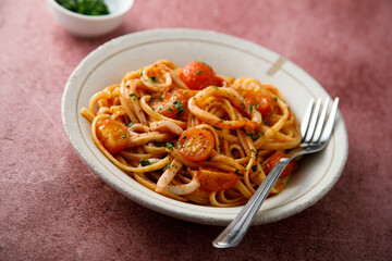 Homemade pasta with tomatoes and squid