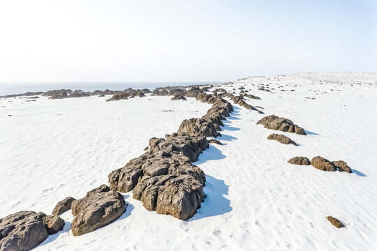 Rocky Outcrop on a White Sandy Beach