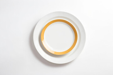 White Plate with Yellow Rim on White Background
