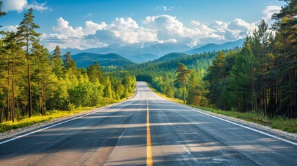 Naklejka premium Scenic Highway Through Lush Forests and Mountains Under a Bright Blue Sky