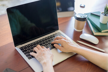 Close-up of hands women working on laptop in office