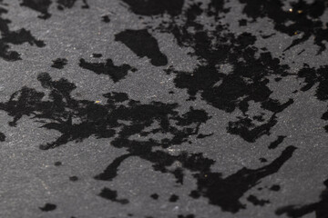 black slate surface for serving in drops of water