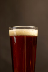 dark beer in a glass glass, fresh dark alcoholic beer