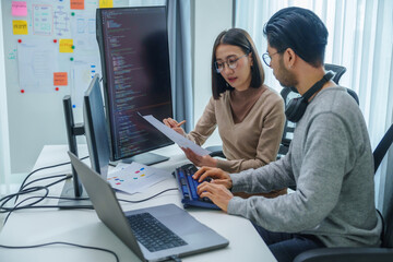 asian and Indian Developer team discussion feedback analysis coding data with software computer at...