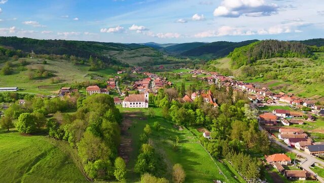 Orbit around the medieval fortified castle and the old church in the historical village of Kreisch - Cris - Keresd. Medieval village in the heart of  Transylvania, Romania.