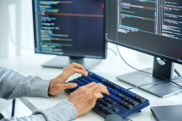 close up  developer hand coding with keyboard on desk  at modern office