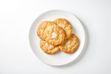 Close-up of four round flatbreads on a white plate