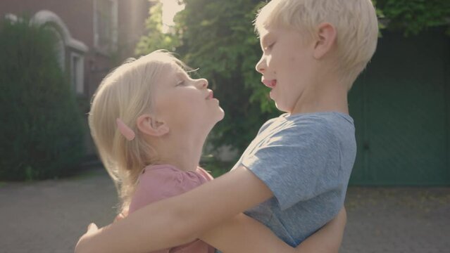 Brother and sister embrace each other