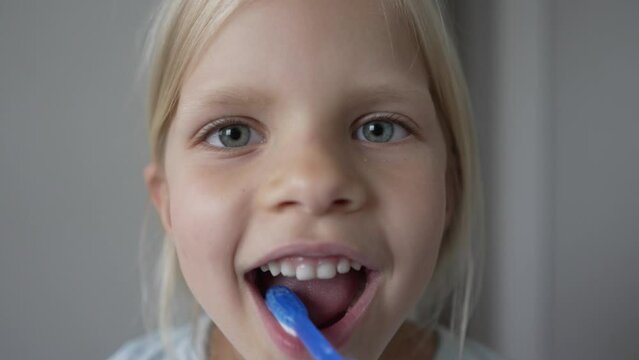 Little girl brushing her teeth