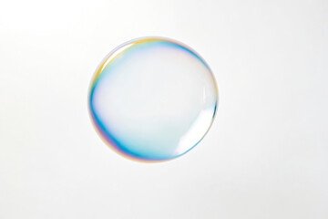Single iridescent soap bubble on a white background