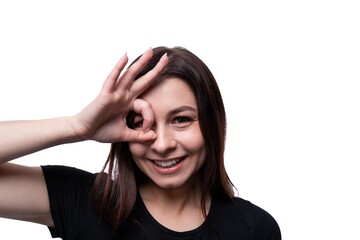 Caucasian young brunette woman with black hair greeting on white background