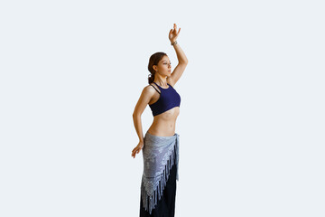 Beautiful young woman dancing oriental belly dance tribal fusion on a white background