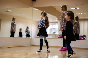 Young Girls Taking a Dance Class with Instructor in Studio with Mirrors