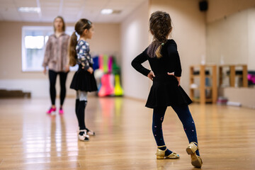 Young Girls Practicing Dance Moves in a Bright Studio with Instructor