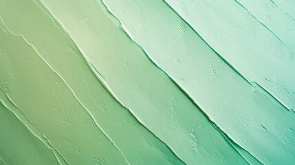 Obraz premium Smooth, parallel diagonal swaths of pale green and cool turquoise paint create a minimalist abstract background perfect for contemporary vertical advertisements.