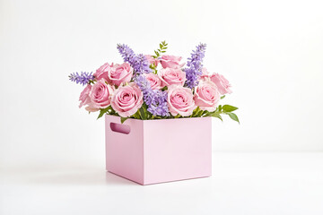 Pink roses and purple flowers in a pink box on a white background
