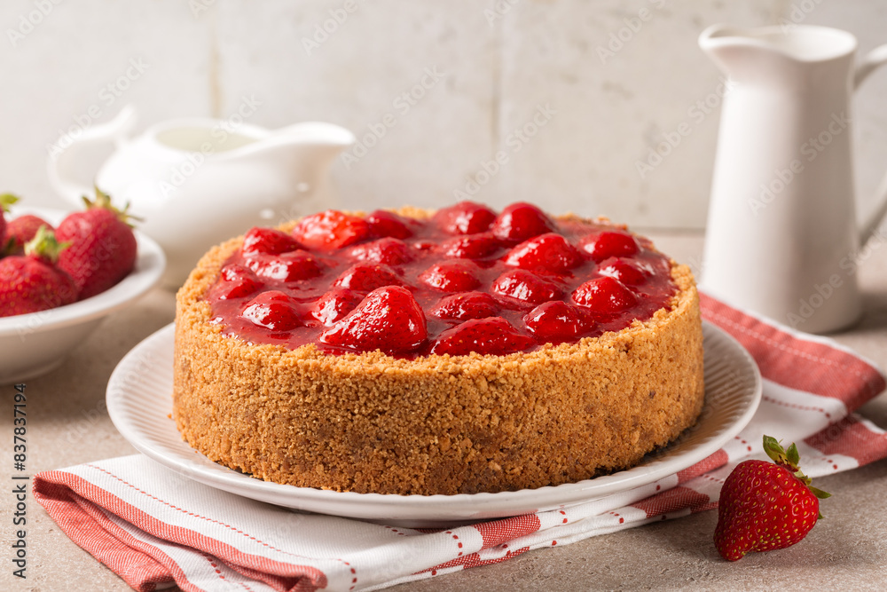 Sticker Whole classic baked cheesecake  with  strawberry and  sauce. Homemade fruit and cheese pie.