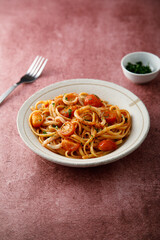 Homemade pasta with tomatoes and squid