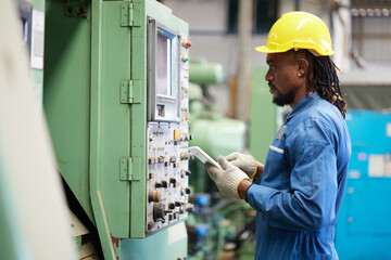 engineer or technician checking and control lathe machine in the factory