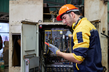 engineer or technician operating industrial control panel in the factory