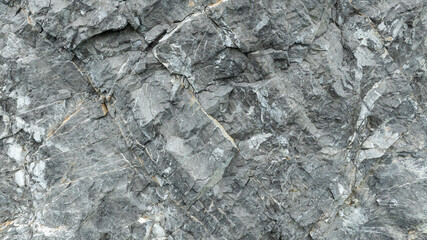 cracked black stone surface texture background.
