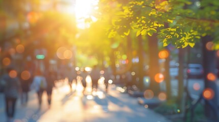 Fototapeta premium Golden hour city street. Blurred image of people walking on a city street at sunset, creating a warm and inviting atmosphere.