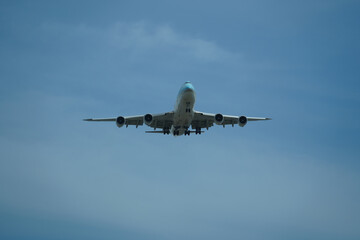 Airplane is flying in the sky with the landing gear down