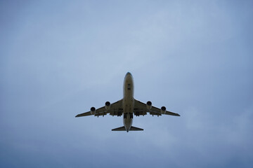 Airplane is flying in the sky with the landing gear down