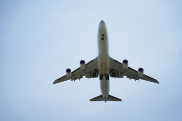 Airplane is flying in the sky with the landing gear down