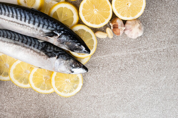 Uncooked mackerel sea fish with lemons and garlic, culinary recipe