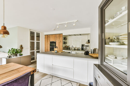Modern kitchen with wood accents and open shelves - Powered by Adobe