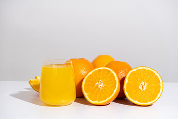 Orange juice in a glass and half a fresh orange, space for text.