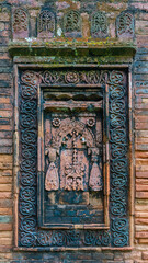 Closeup vertical view of brick and terracotta decor on exterior wall of ancient medieval Goaldi mosque, Sonargaon, Bangladesh