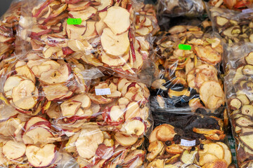 A pile of apples in plastic bags, dried fruits