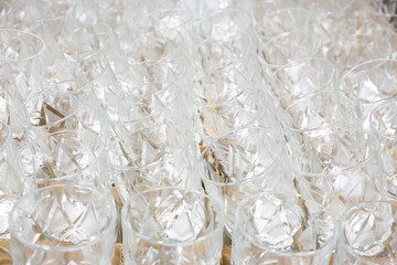 A row of glasses are lined up on a table