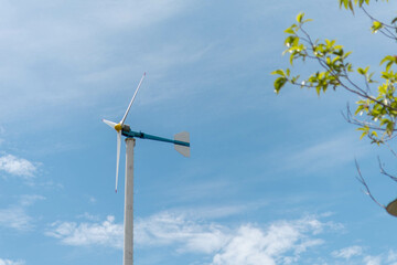 A wind turbine generating clean energy against a blue sky