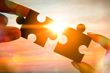 Business person hand holding puzzle piece. Closeup part of two jigsaw connect together. join...