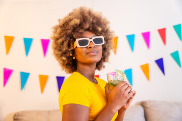 Portrait of an african woman with sunglasses and cocktail glass