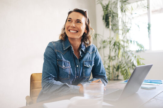 Thoughtful businesswoman working at her office desk
