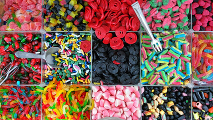 Colorful background of stacks of colorful and sweet gummies in the market