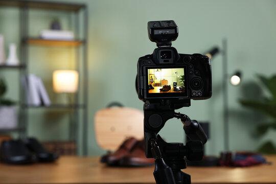 Beauty blogger's workplace. Men's accessories on table indoors, focus on camera
