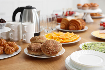 Different meals served on wooden table indoors. Buffet menu