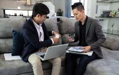 Two asian man with laptop and financial management or planning.