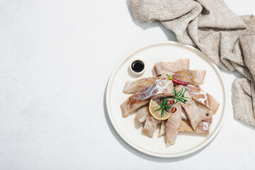 Raw pollock (Pollachius virens) fillet. Fresh fish for healthy food lifestyle. Spices and herbs